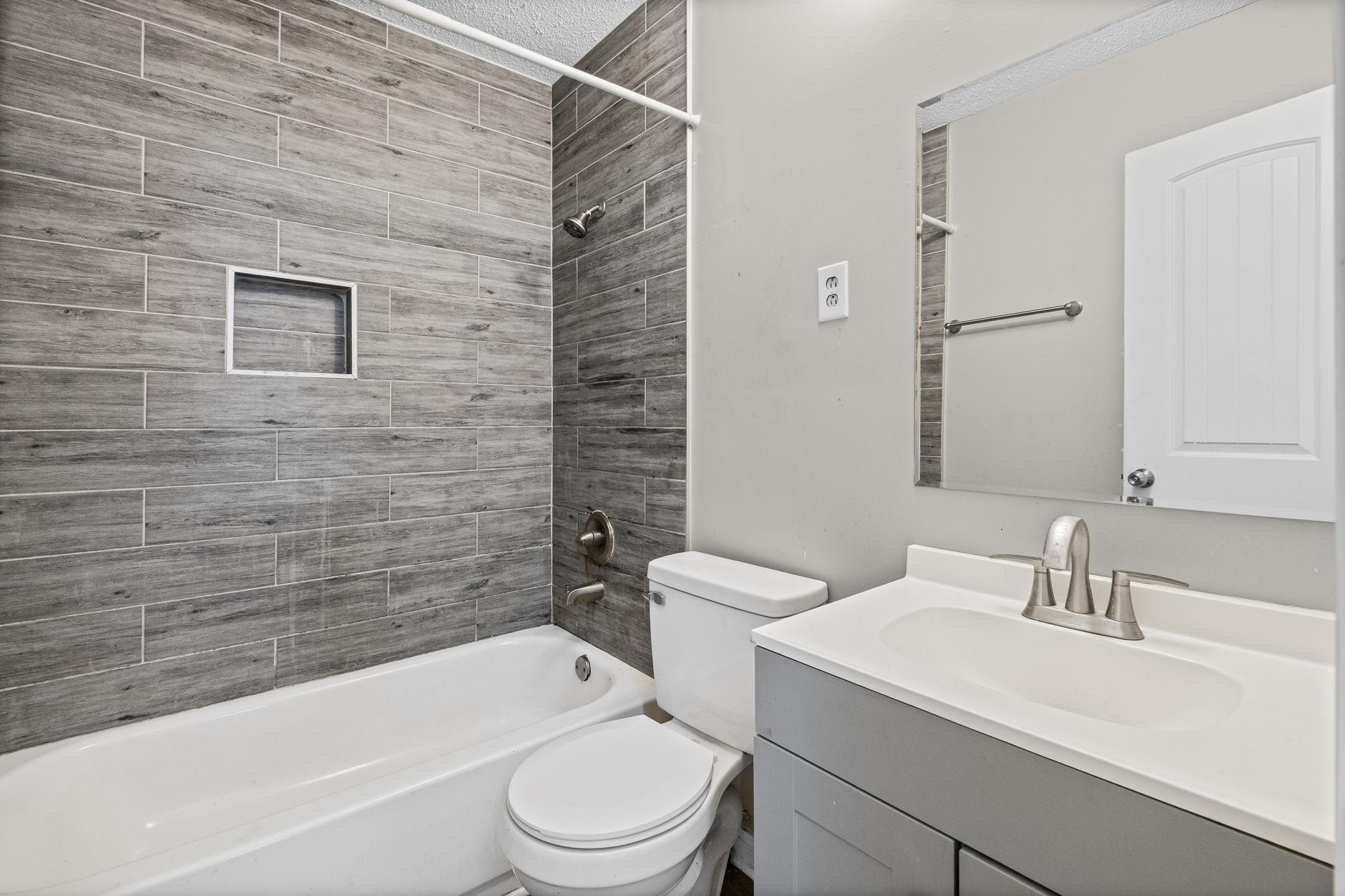 4202 Reed Avenue Memphis, TN 38108 - Photo 13 of 22 Full bathroom featuring vanity and bathtub / shower combination