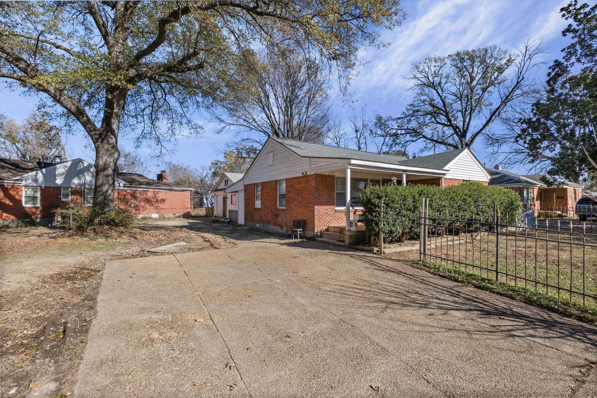4202 Reed Avenue Memphis, TN 38108 - Photo 3 of 22 View of side of home with brick siding and concrete driveway
