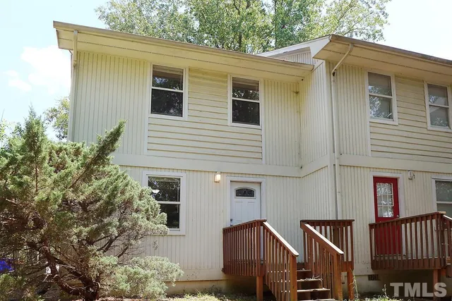 a view of a house with a yard and sitting area