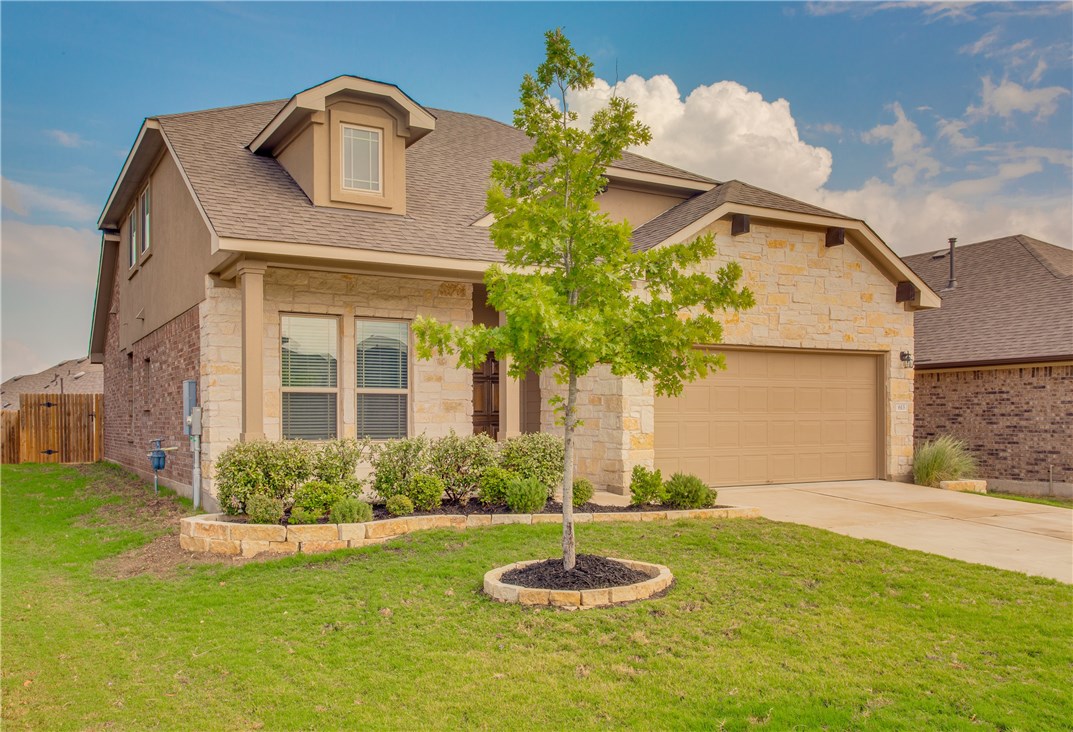 a front view of a house with a yard