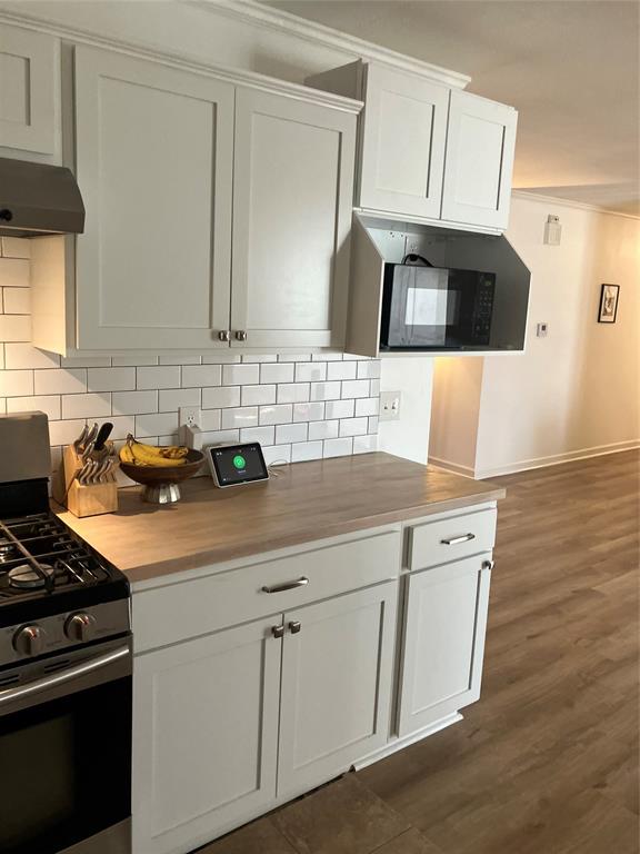 233 Church Road Stonewall, LA 71078 - Photo 30 of 32 Kitchen with range, ventilation hood, and white cabinetry