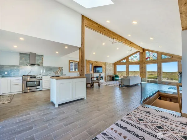 a kitchen with stainless steel appliances granite countertop a refrigerator and a stove top oven