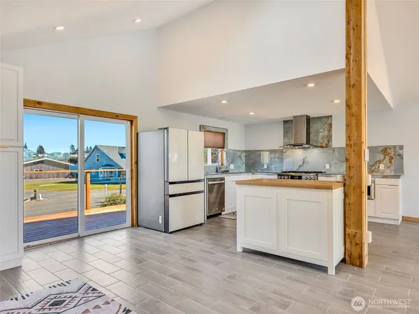 a kitchen with stainless steel appliances granite countertop a stove a sink and a microwave