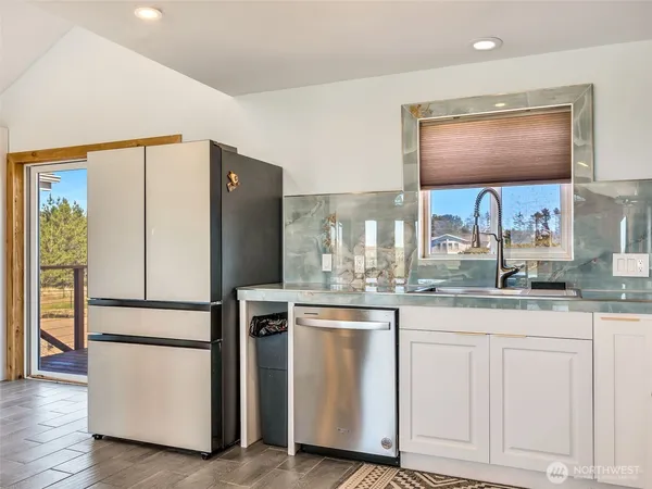 a stove top oven sitting inside of a kitchen