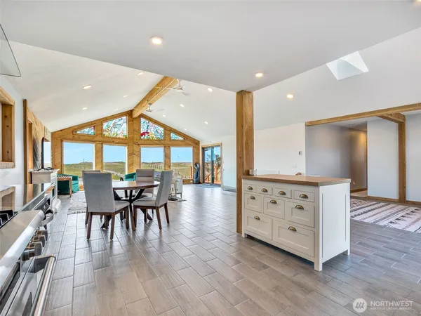 a living room with furniture and large windows