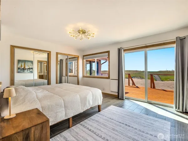 a bedroom with a large bed and a chandelier