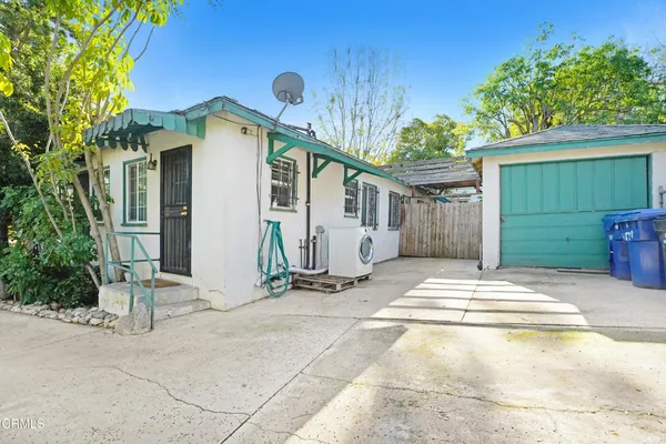 a view of a house with backyard and sitting area