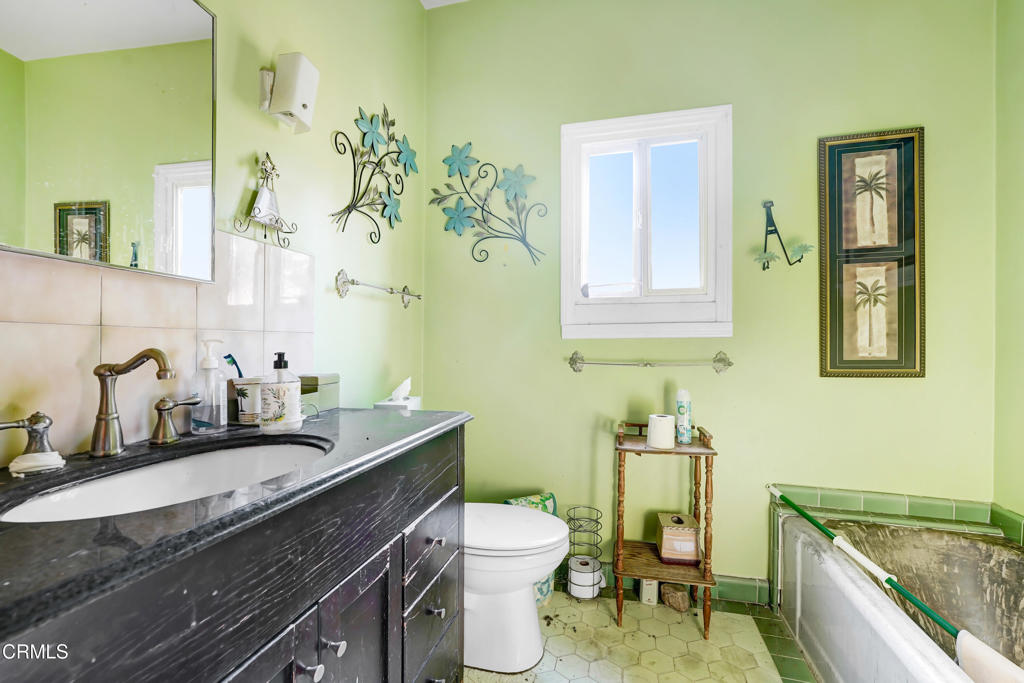 4824 Toland Way Los Angeles, CA 90041 - Photo 19 of 26 a bathroom with a granite countertop toilet sink and mirror