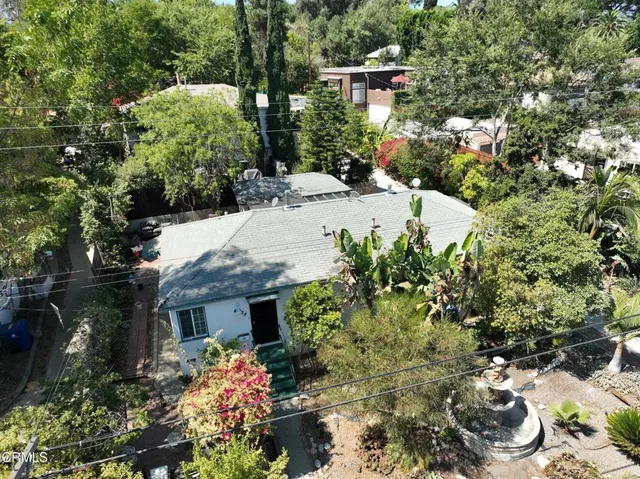 an aerial view of a house with a yard and lake view