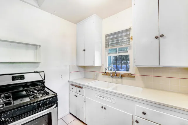 a kitchen with a stove and a sink