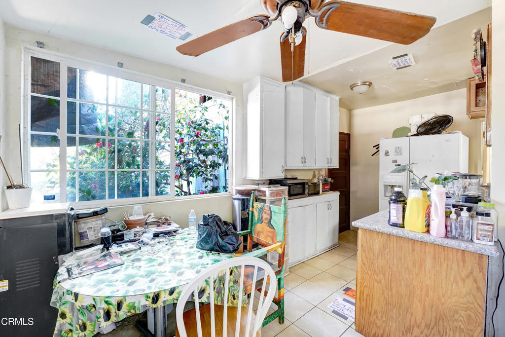 4824 Toland Way Los Angeles, CA 90041 - Photo 6 of 26 a kitchen with sink refrigerator dining table and chairs