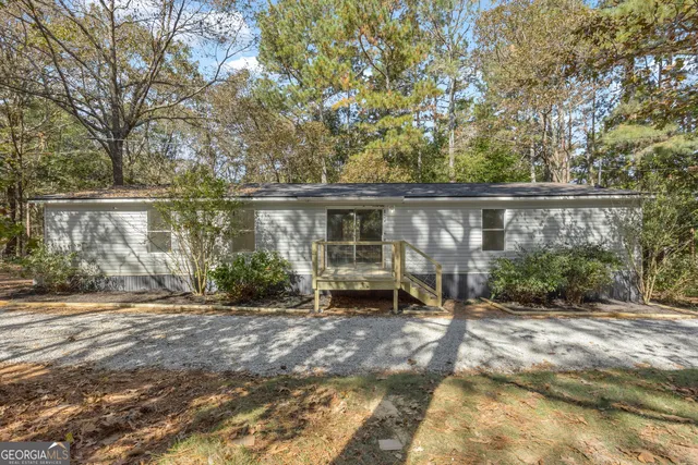 a backyard of a house with yard and outdoor seating
