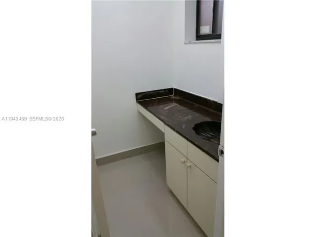 a white toilet sitting next to a white sink