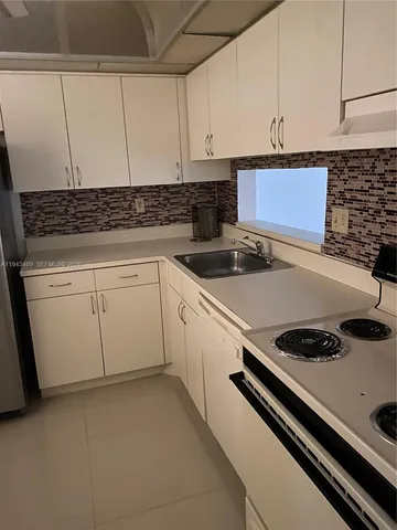 a view of a storage and utility room with washer and dryer