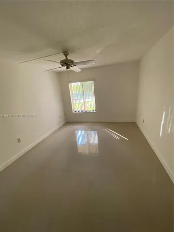 an empty room with a empty space and windows