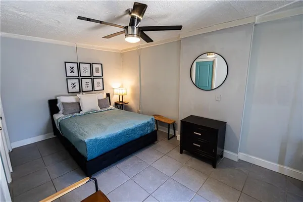 a bedroom with a bed and a chandelier