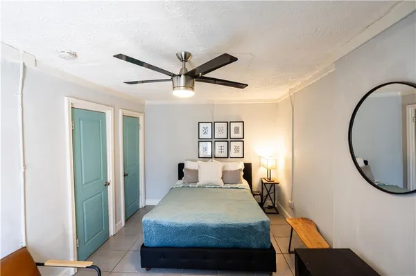 a bedroom with a bed and a mirror