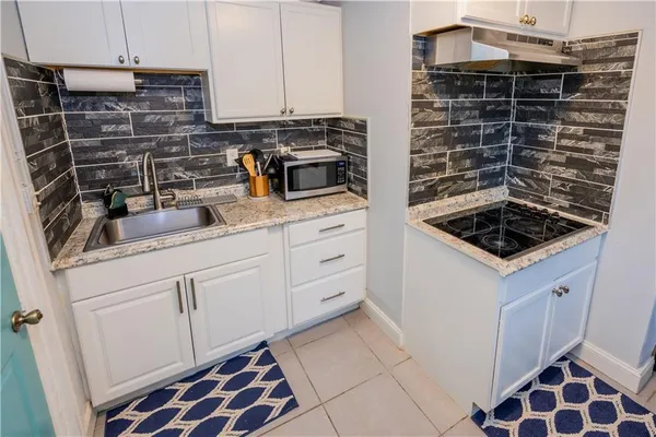 a kitchen with a sink and cabinets