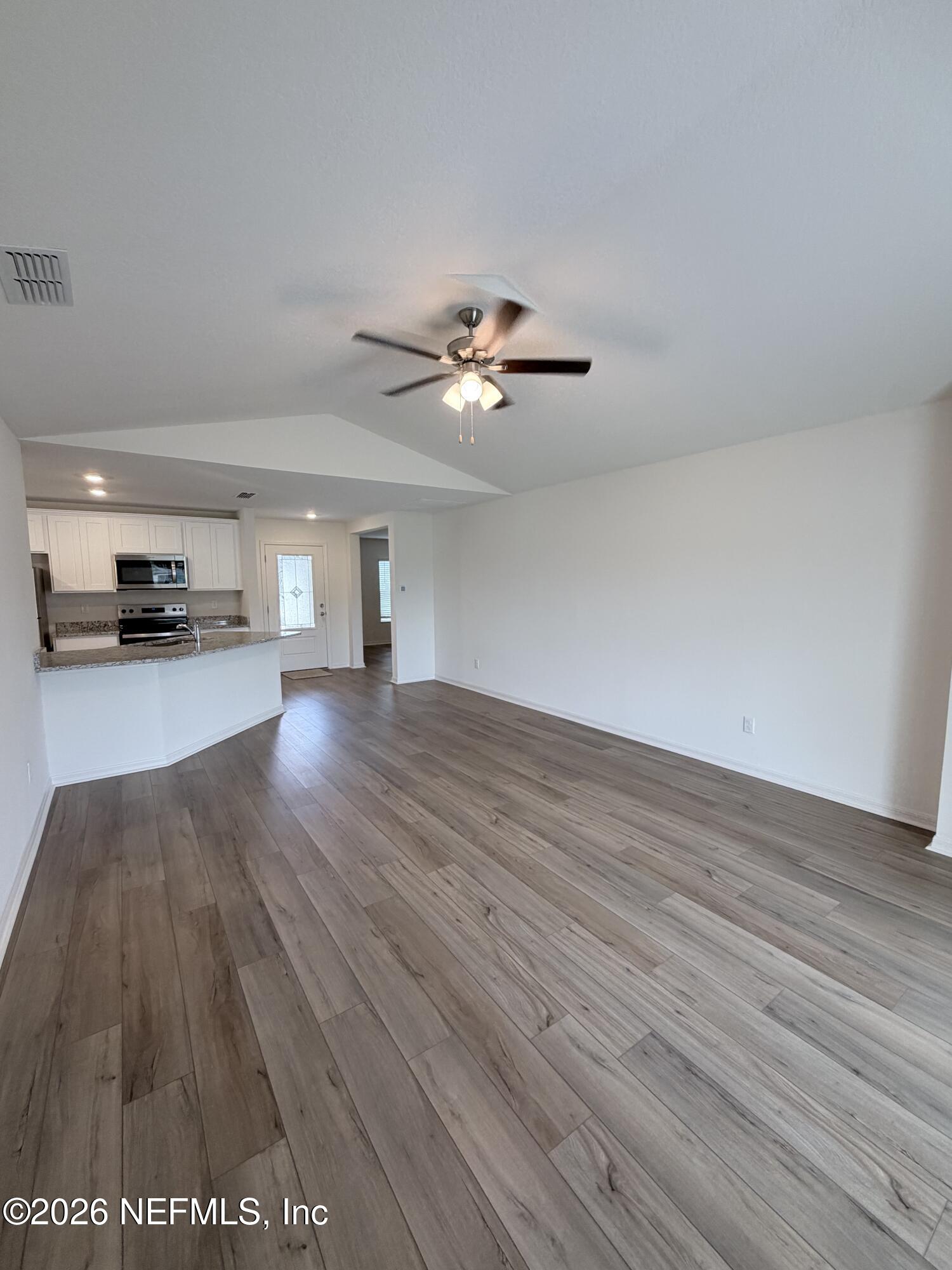 37397 Whisper Way Hilliard, FL 32046 - Photo 8 of 9 a view of a room with wooden floor and a ceiling fan