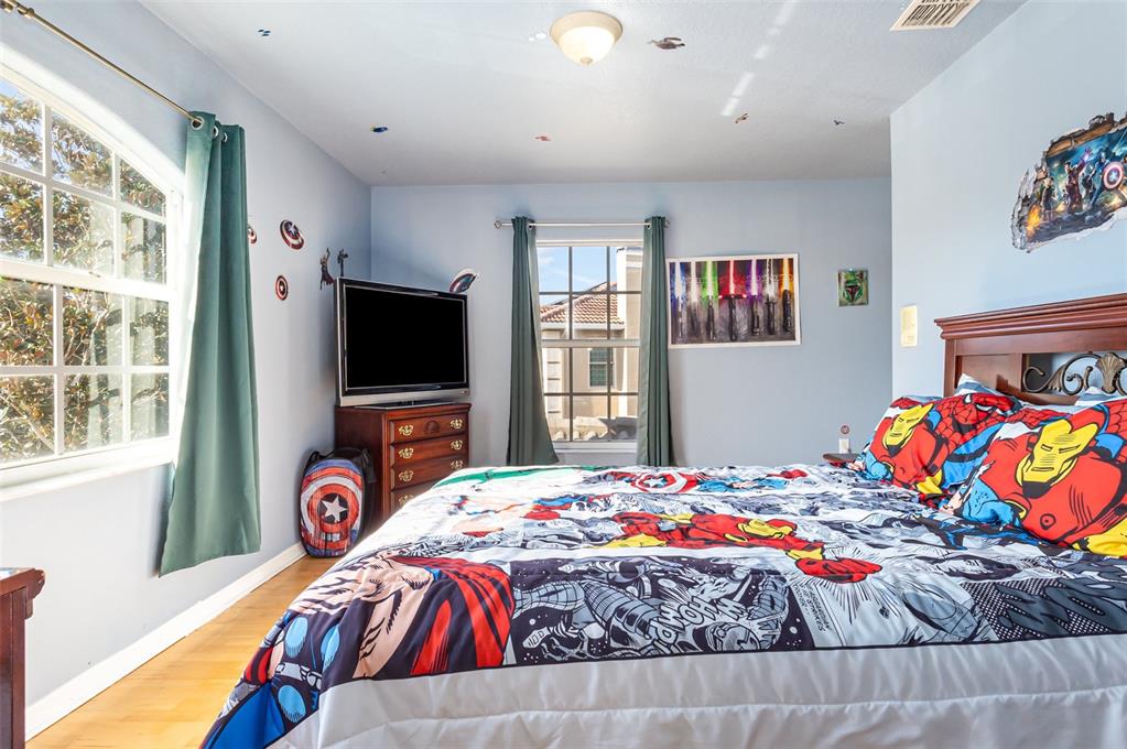 302 Vista Loop Davenport, FL 33897 - Photo 17 of 22 a bedroom with a bed and a flat screen tv