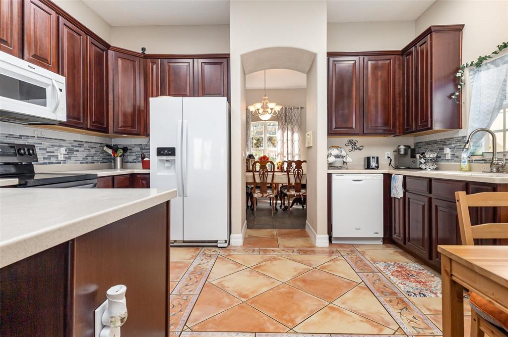 302 Vista Loop Davenport, FL 33897 - Photo 6 of 22 a kitchen with refrigerator and cabinets