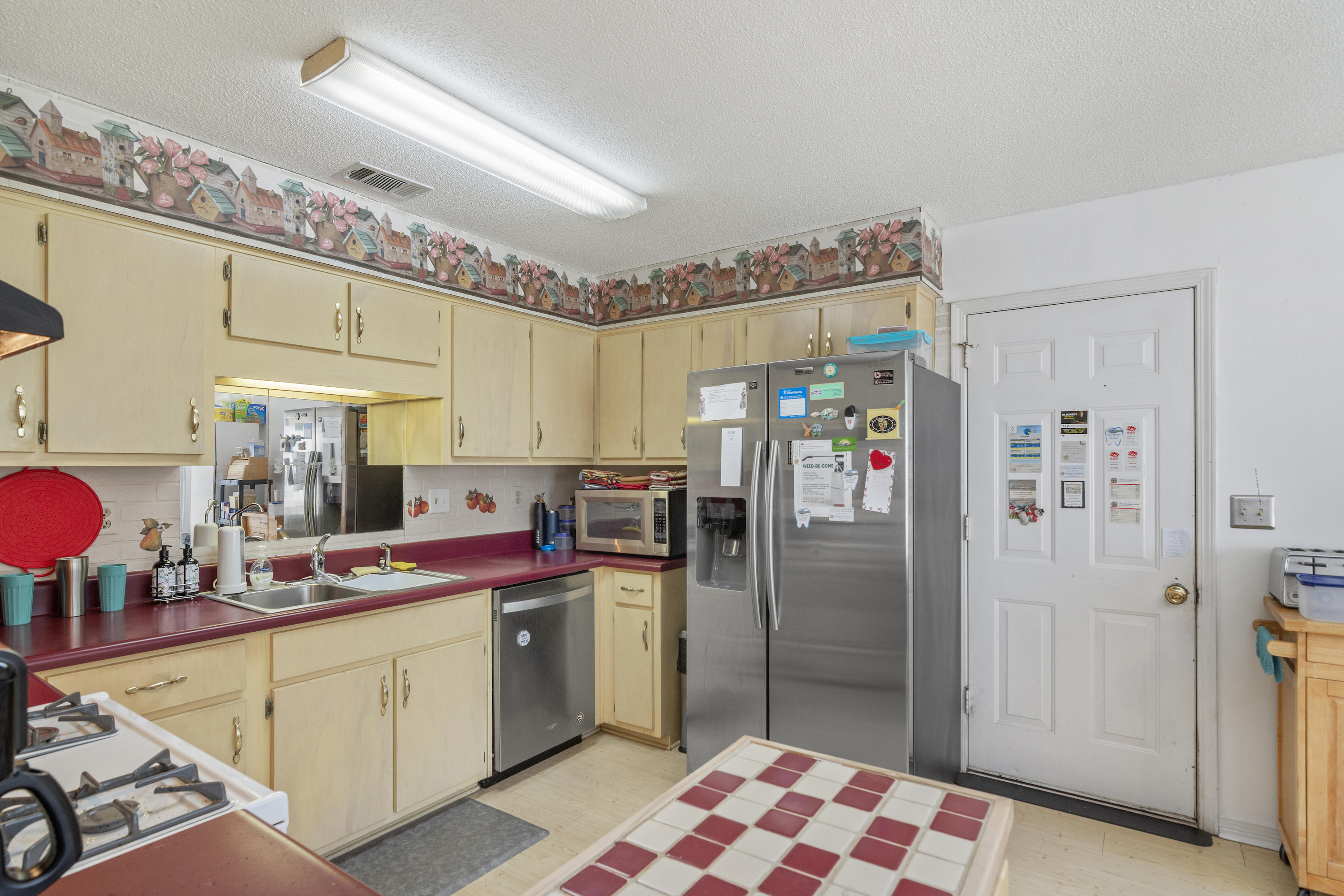 216 Brookmeade Drive Crestview, FL 32539 - Photo 11 of 29 a kitchen with refrigerator and cabinets