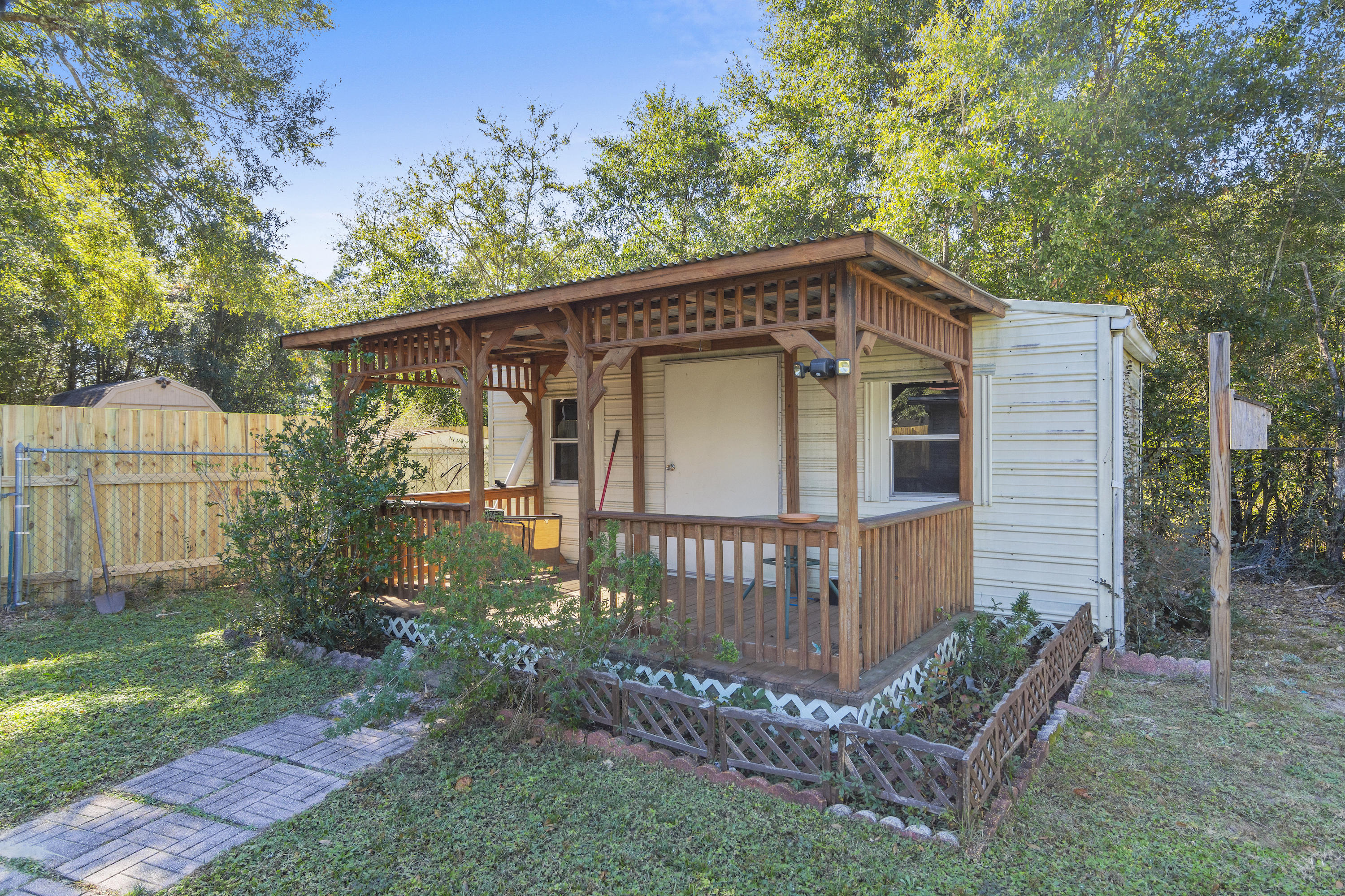 216 Brookmeade Drive Crestview, FL 32539 - Photo 23 of 29 a view of a small house with a small yard and a large tree