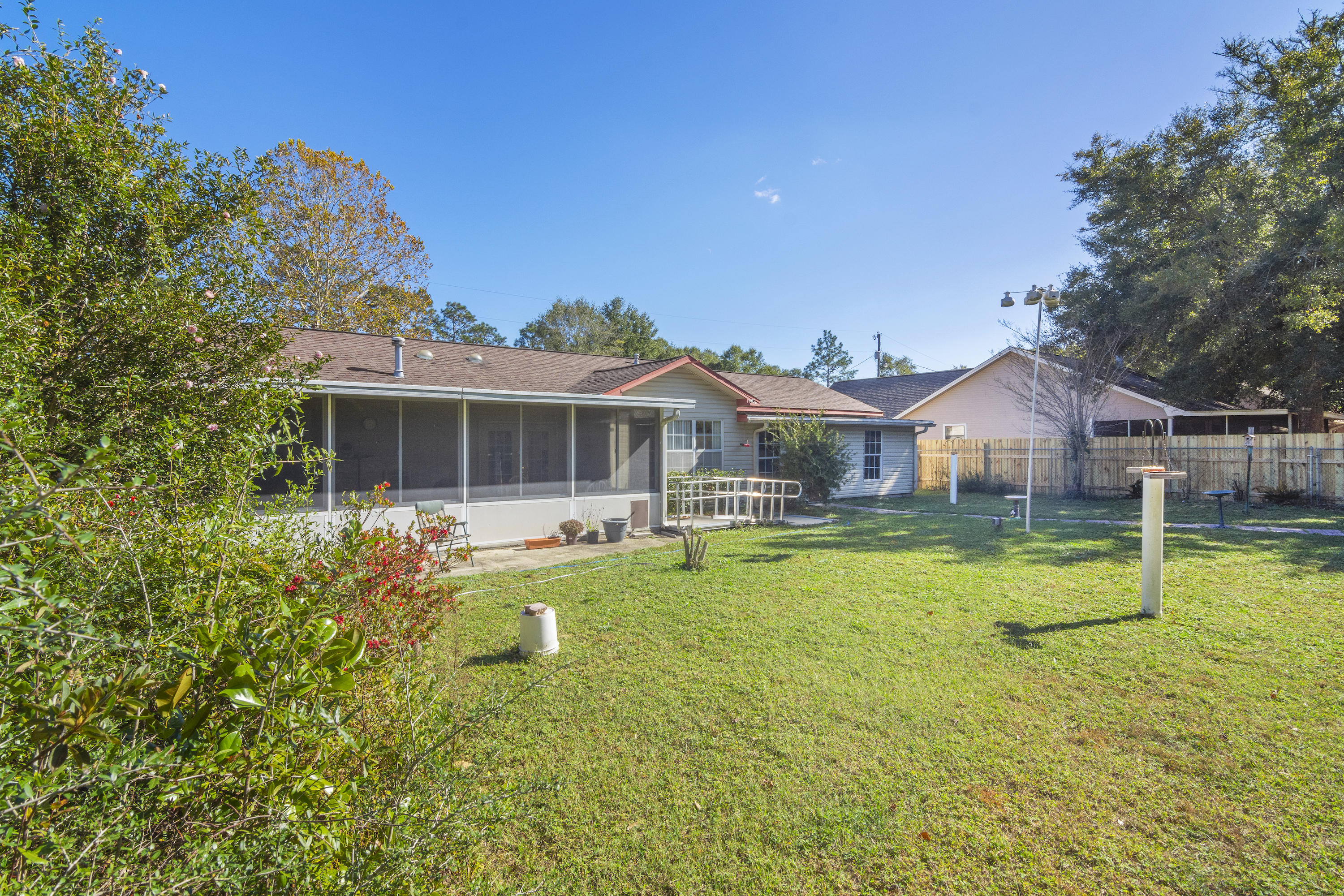 216 Brookmeade Drive Crestview, FL 32539 - Photo 24 of 29 a front view of house with swimming pool and porch with furniture