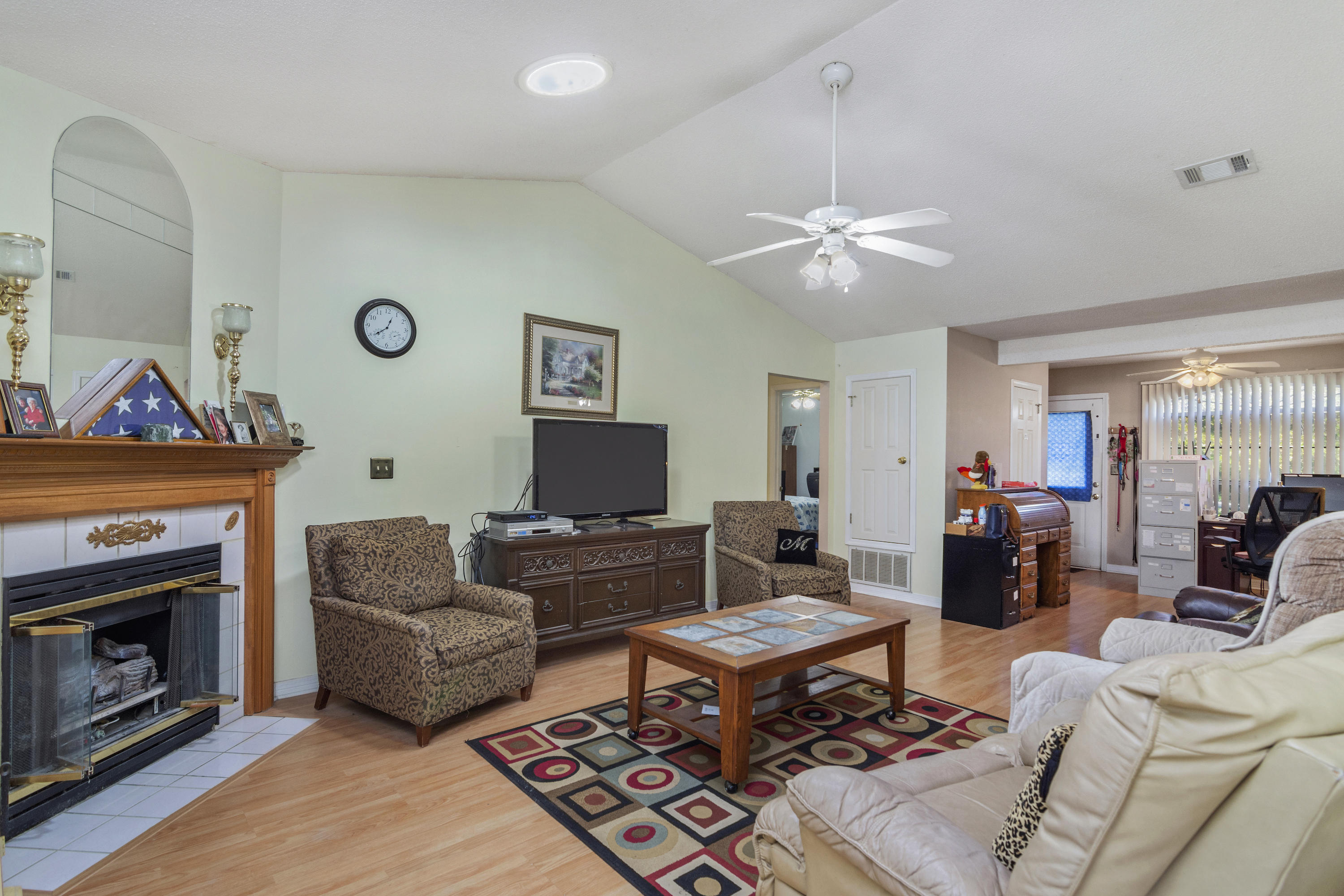 216 Brookmeade Drive Crestview, FL 32539 - Photo 5 of 29 a living room with furniture a fireplace and a flat screen tv
