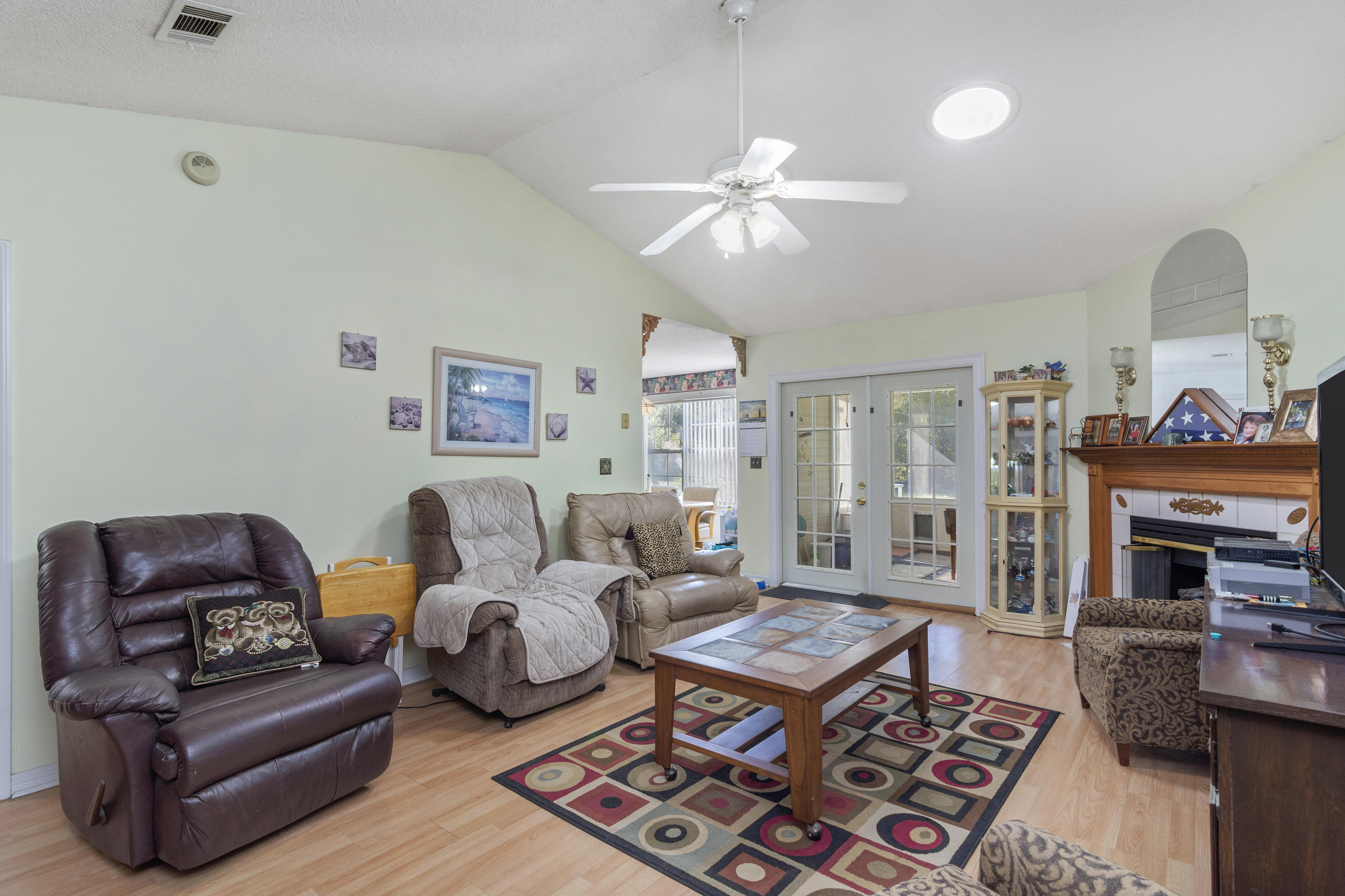 216 Brookmeade Drive Crestview, FL 32539 - Photo 7 of 29 a living room with furniture a flat screen tv and a fireplace