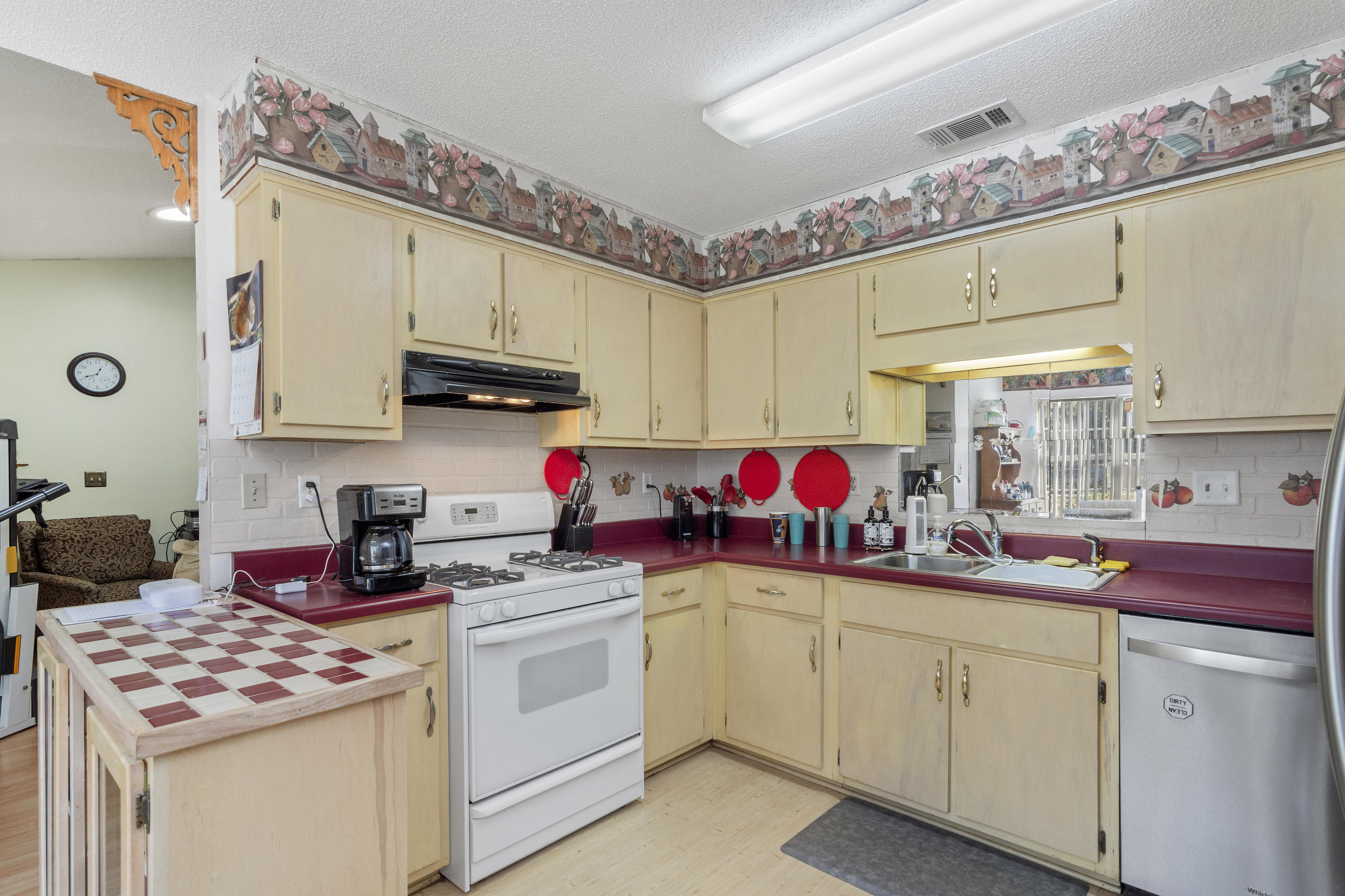 216 Brookmeade Drive Crestview, FL 32539 - Photo 10 of 29 a kitchen with kitchen island a sink cabinets and window
