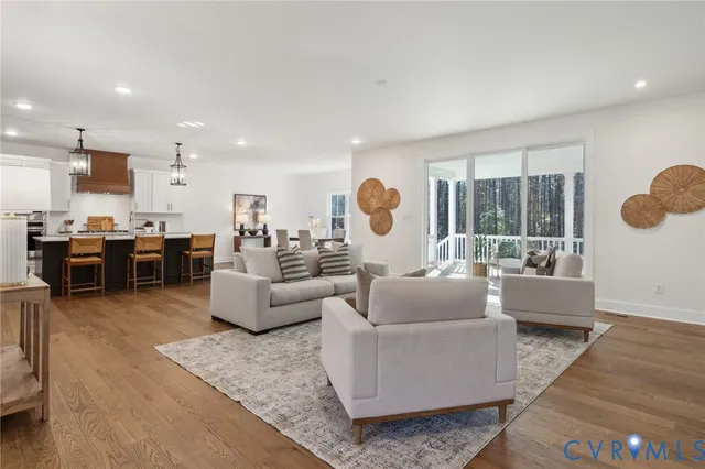 a living room with furniture and wooden floor