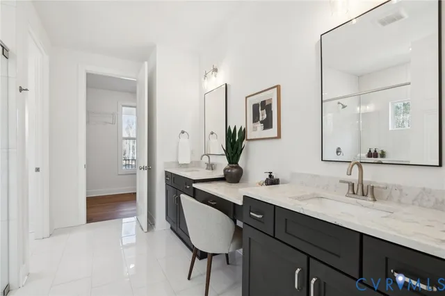 a bath room with a sink double vanity and a mirror