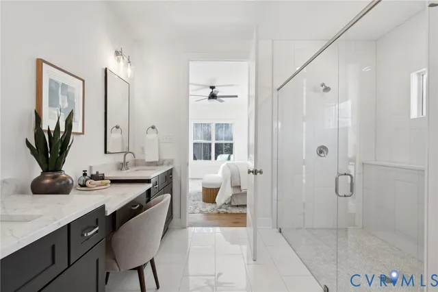 a en suite bathroom with a granite countertop sink and a mirror