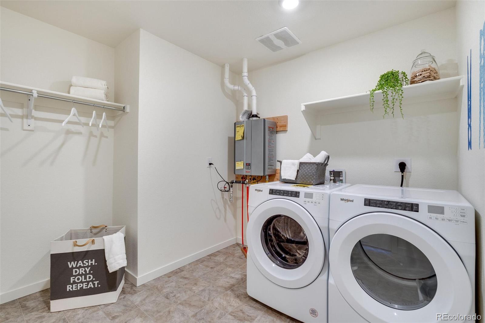 830 Elias Tarn Drive Severance, CO 80550 - Photo 28 of 30 a utility room with dryer and washer