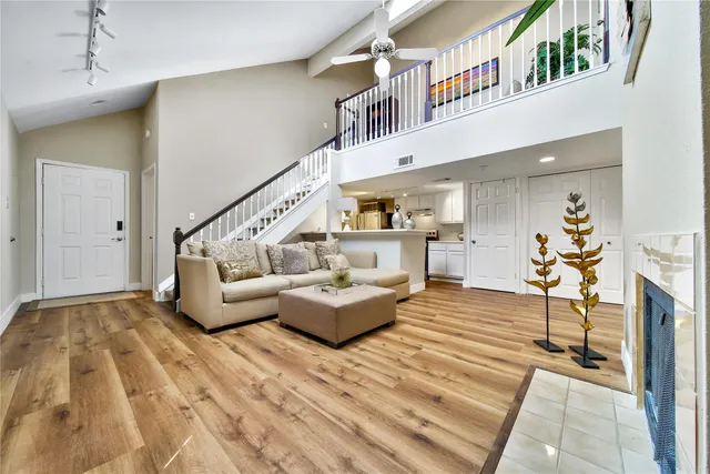 a living room with furniture and a wooden floor