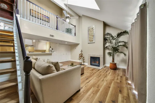 a living room with furniture a fireplace and a flat screen tv