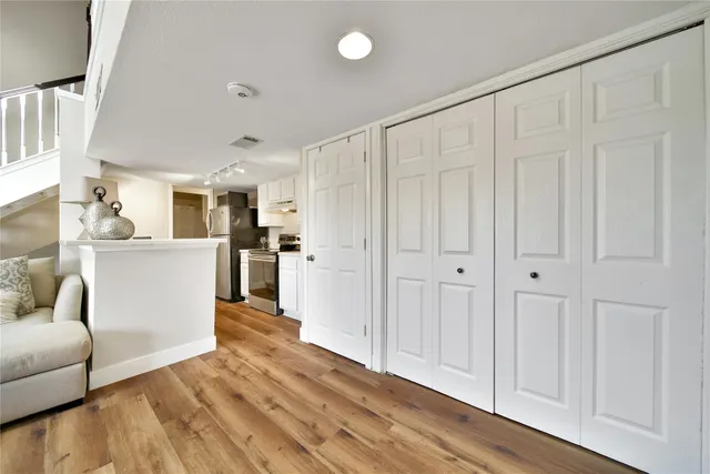 a view of a kitchen with furniture and wooden floor