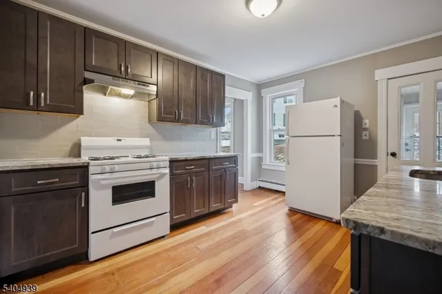 a kitchen with a stove a refrigerator and a sink