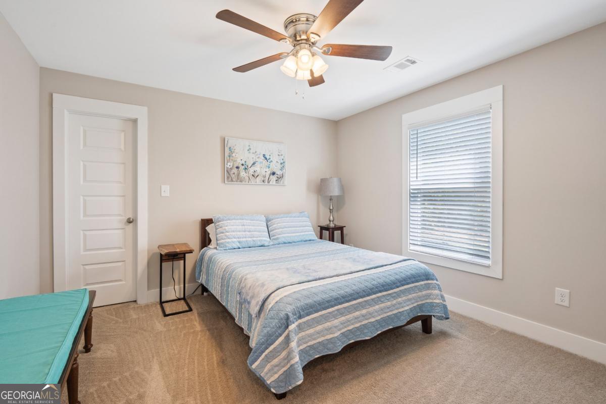 801 Holly Ridge Drive Gray, GA 31032 - Photo 34 of 51 a bedroom with a bed and a chandelier