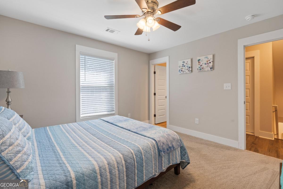 801 Holly Ridge Drive Gray, GA 31032 - Photo 35 of 51 a bedroom with a large bed and a window