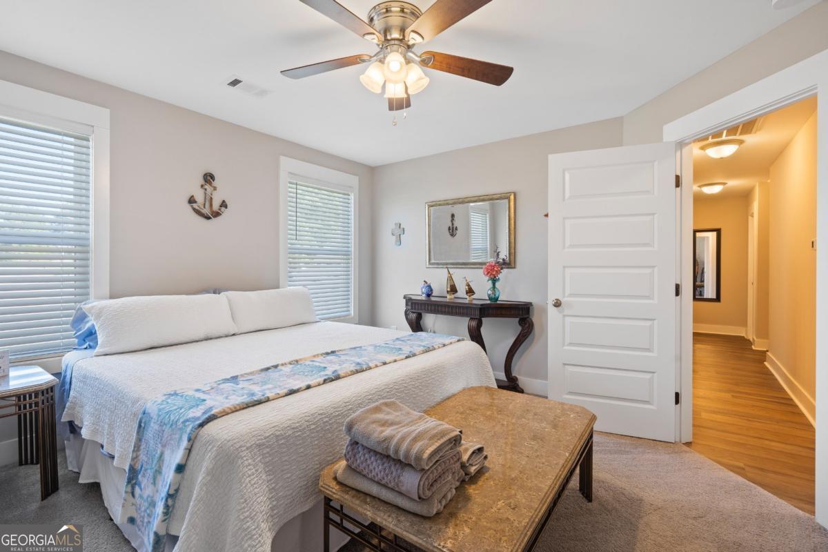 801 Holly Ridge Drive Gray, GA 31032 - Photo 39 of 51 a bedroom with a bed and a chandelier