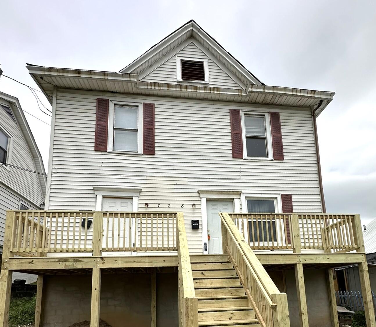a view of a house with wooden deck