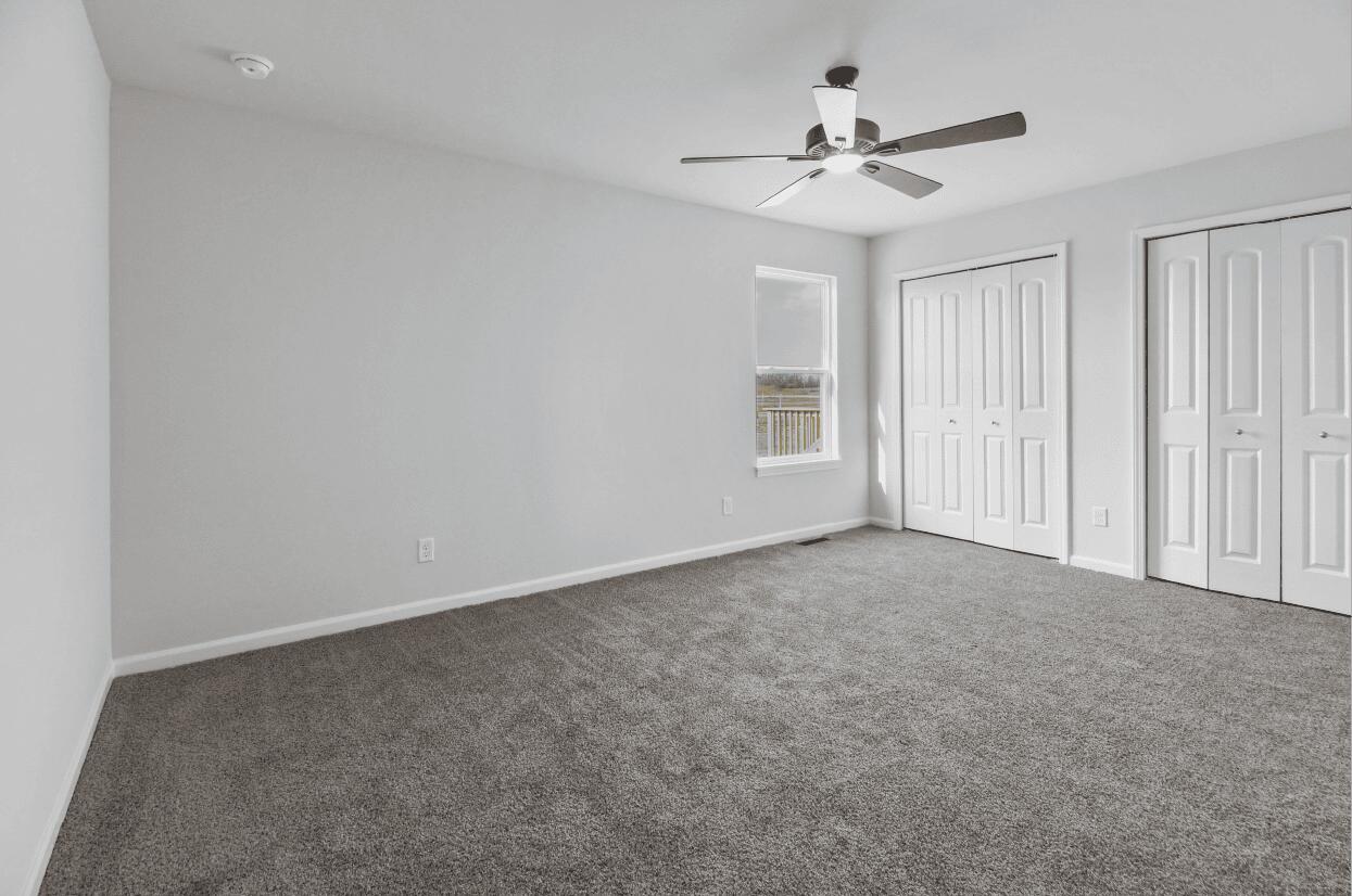 3103 West 82nd Place, Unit 52B Merrillville, IN 46410 - Photo 7 of 18 a view of a livingroom with a ceiling fan and window