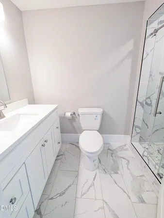 a spacious bathroom with a sink a toilet and a mirror