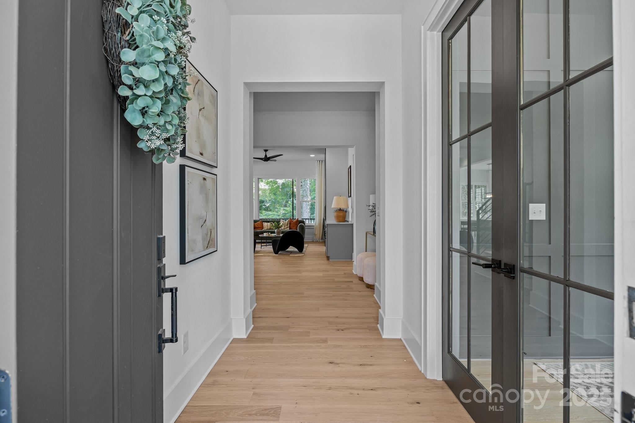 3949 Plainview Road Charlotte, NC 28208 - Photo 14 of 42 a view of a hallway with a potted plant next to a large window