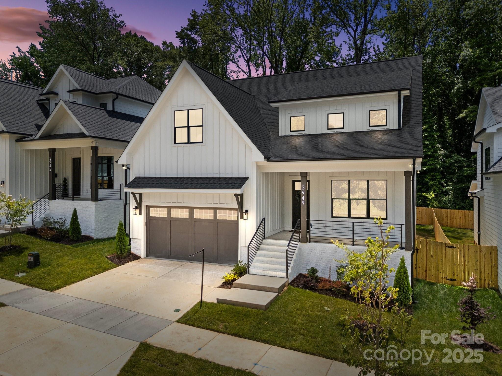 3949 Plainview Road Charlotte, NC 28208 - Photo 2 of 42 a front view of a house with a yard and garage