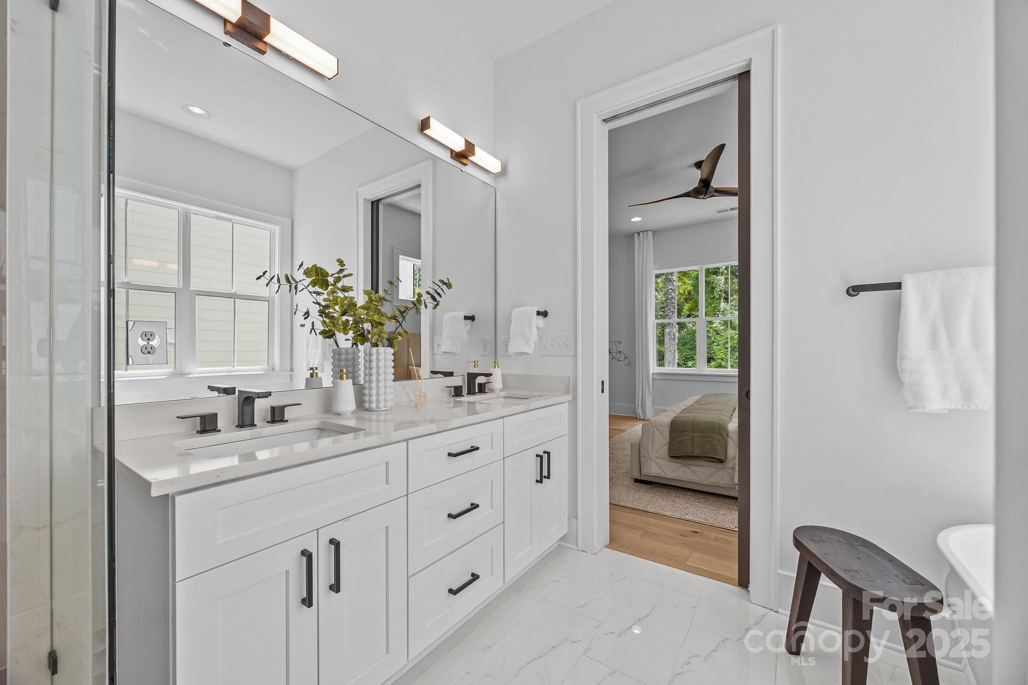 3949 Plainview Road Charlotte, NC 28208 - Photo 24 of 42 a en suite bathroom with a double vanity sink and a mirror
