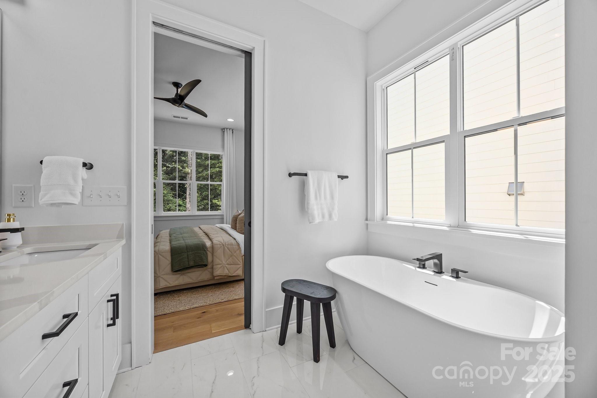 3949 Plainview Road Charlotte, NC 28208 - Photo 26 of 42 a bathroom with a tub sink and mirror
