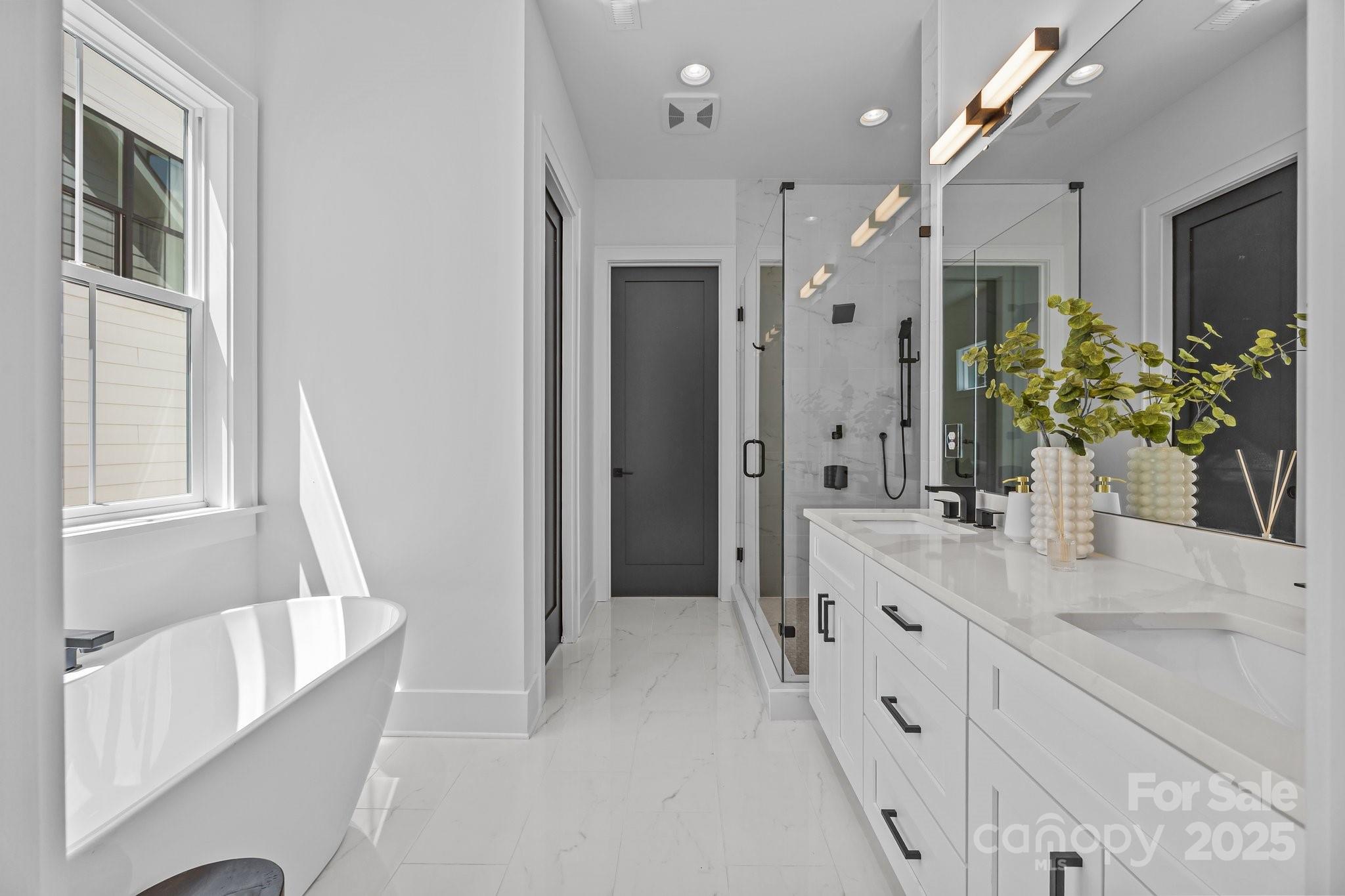 3949 Plainview Road Charlotte, NC 28208 - Photo 27 of 42 a spacious bathroom with a double vanity sink and a mirror